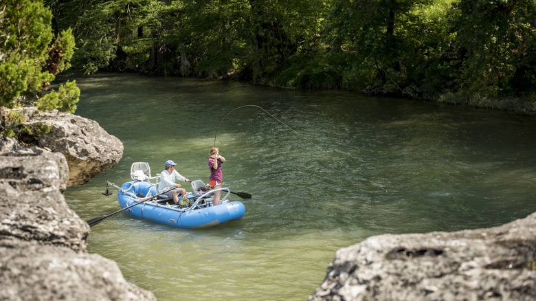 people fishing on a dinghy