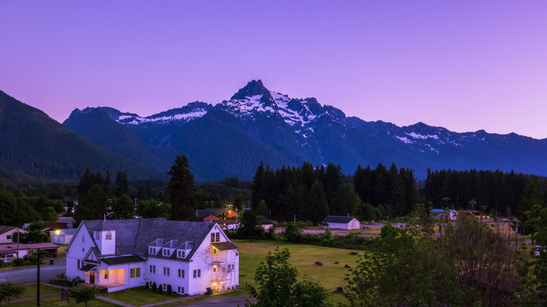A mountain rises above the town of Darrington, Washington at dusk