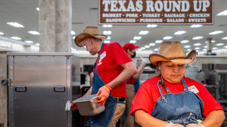Buc-ee's employees make food while wearing cowboy hats