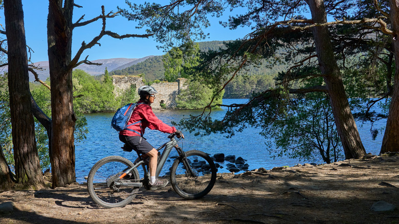 Cyclist traveling through Loch an Eilein