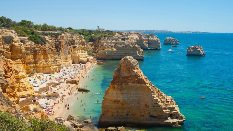 cliffs, a beach, and blue sea