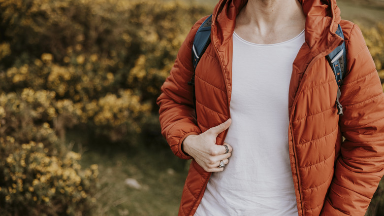 A person in an orange puffer jacket.