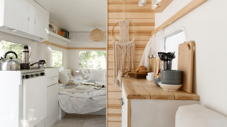 White and wood decor inside a campervan.