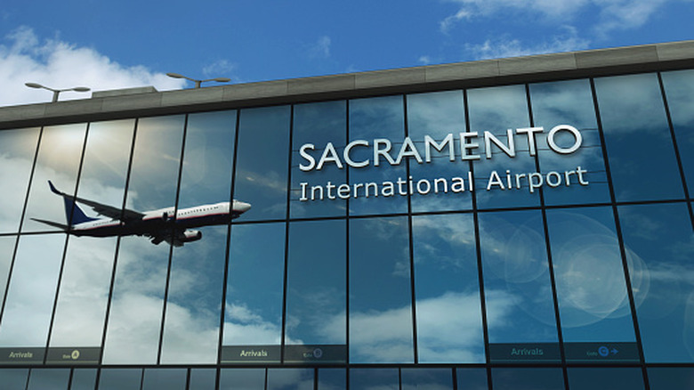 Aircraft landing reflected in windows of Sacramento Airport