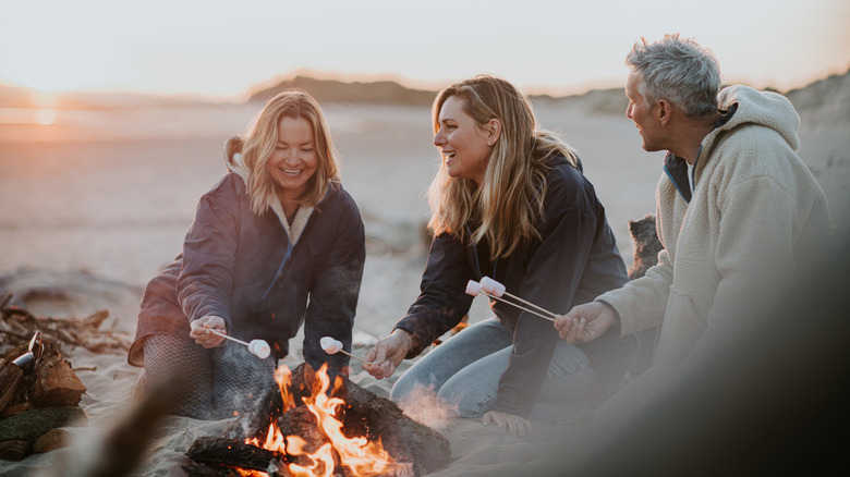 A family toasts marshmallows together.