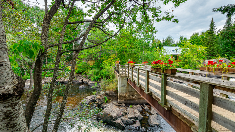 A footbridge with pretty flower boxes over the river in Val-David