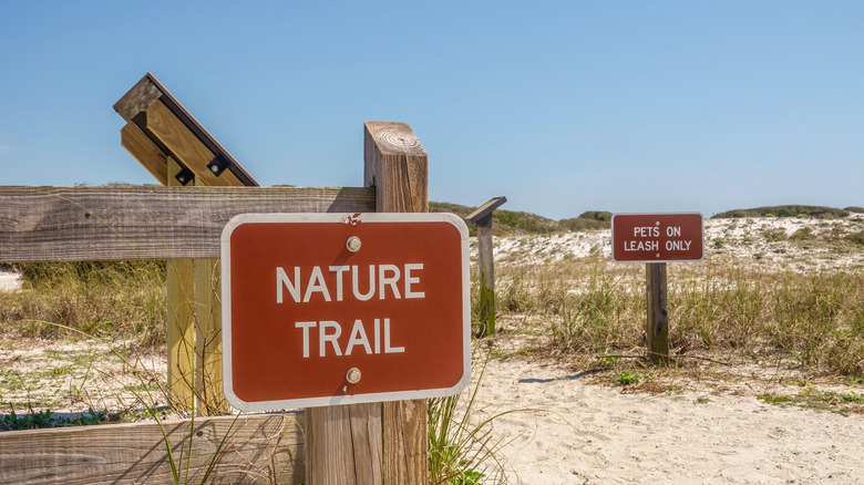 two signs at trailhead, grayton beach state park, florida