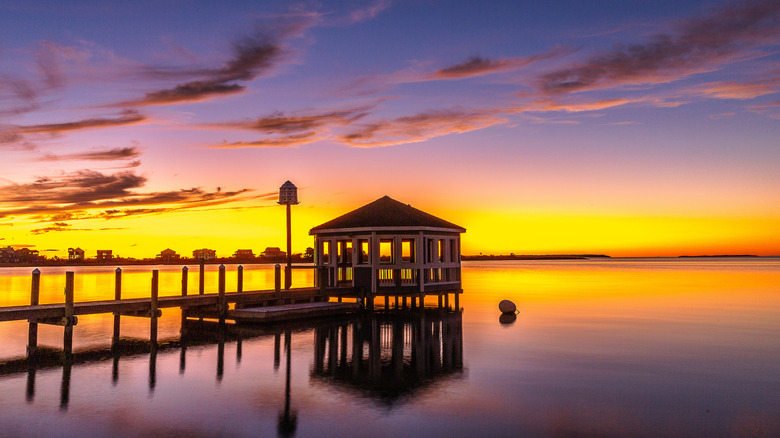 building on a pier at sunset