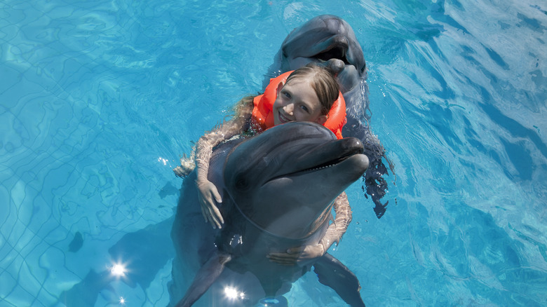 Girl hugging a dolphin
