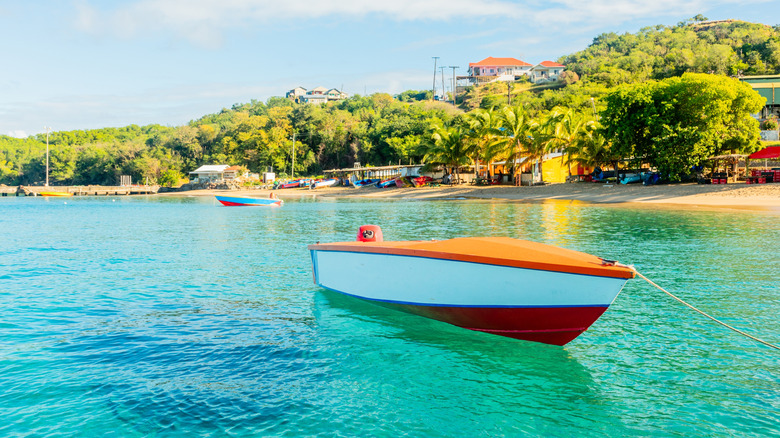 Boat in a bay with turquoise water, Mayreau island