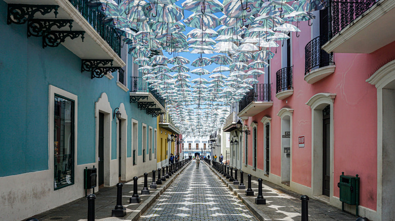 Umbrellas are festooned above a colorful street in San Juan, Puerto Rico