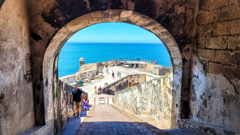 Tourists climb the battlements of El Morro in San Juan