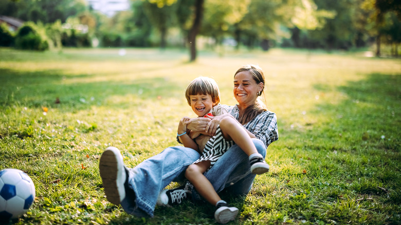 Mother and son play together in the park