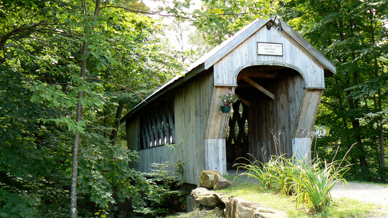 A covered bridge spans a river in Laconia, New Hampshire
