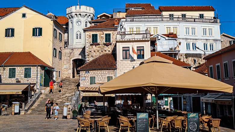 Whitewashed facades stand in a row in Herceg Novi's main square