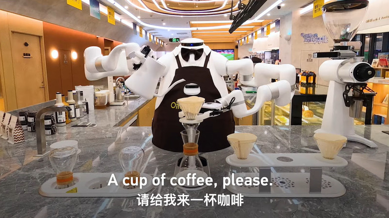 A headless robot pouring coffee into a pour-over coffee pot