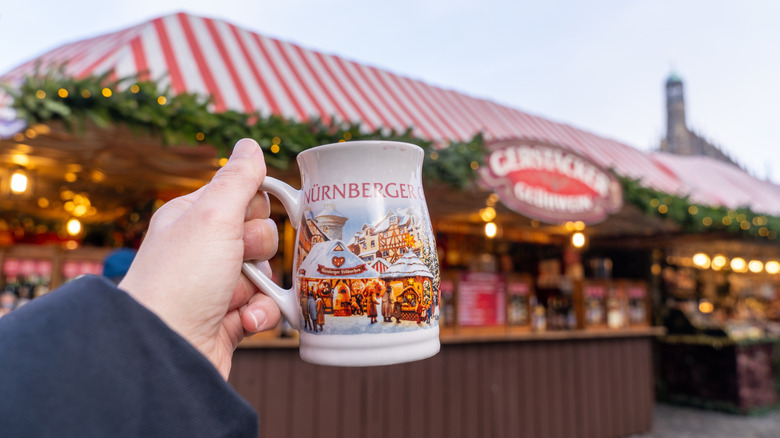 A hand holding a Nuremberg Christmas market mug