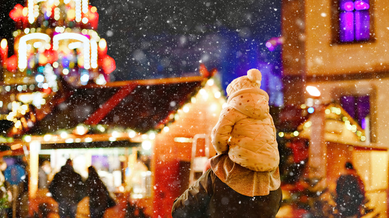 A child being carried on shoulders in Christmas Market