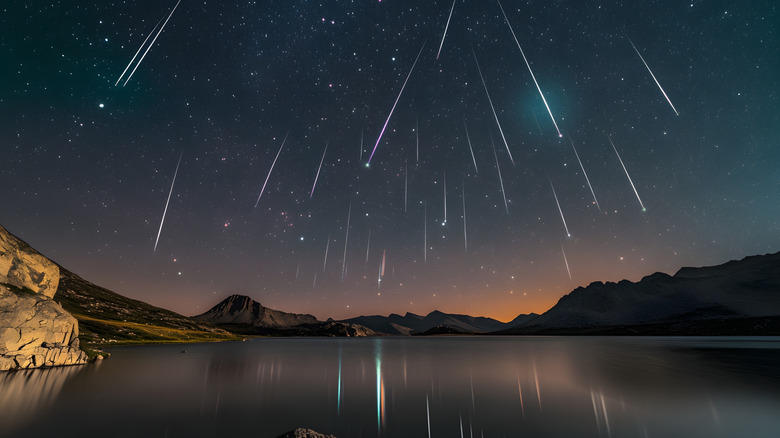 The Perseids meteor shower falling over lake