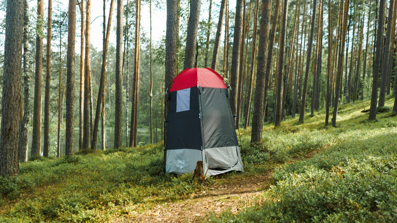 A pop up changing camping tent in the woods