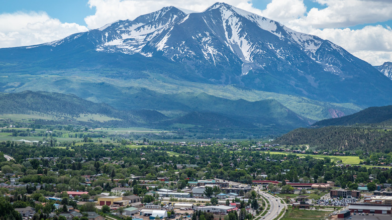 the town of Carbondale sits below snowcapped Mount Sopris in the Rocky Mountains of Colorado