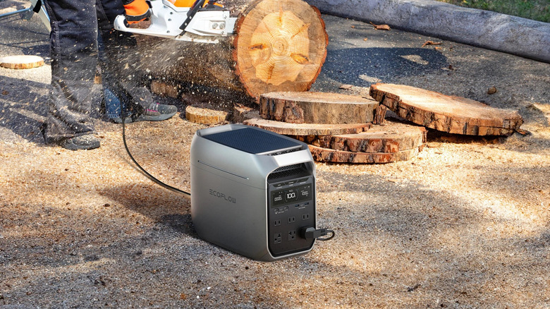 A person uses a power tool powered by the EcoFlow power station.