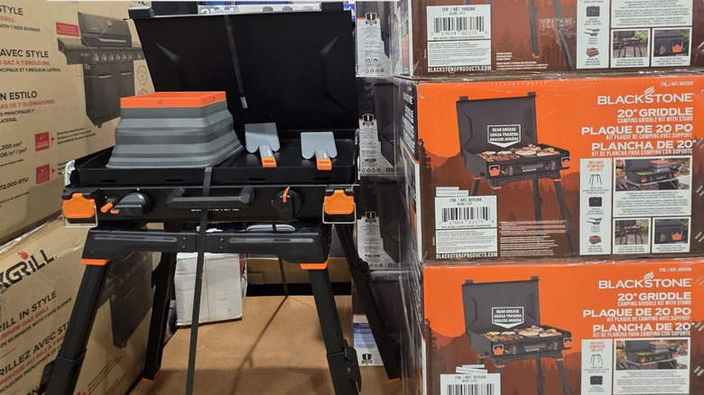 Costco camping griddle display next to product boxes.
