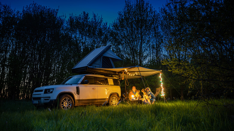 car camping setup with tent at night