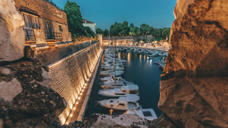 Rocks and harbor at sunset
