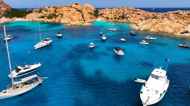 Boats rest on blue Mediterranean waters off the coast of Sardinia