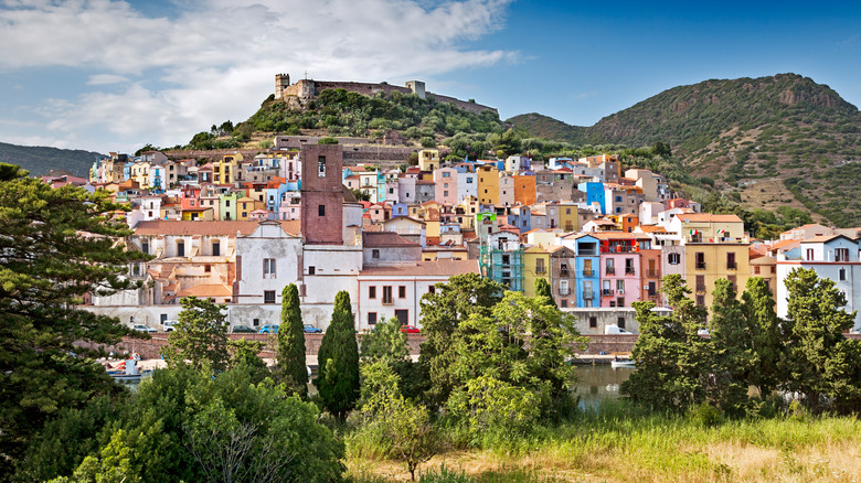 Colorful old buildings grace a hillside in Sardinia