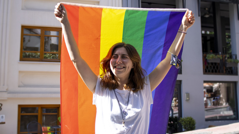 Activist holds LGBTQ flag