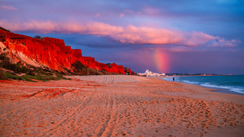 orange clifs and rainbow on the beach