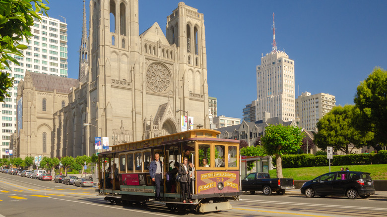 Cable car passengers standing Grace Cathedral