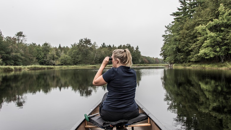 A blonde woman canoes in Keji National Park