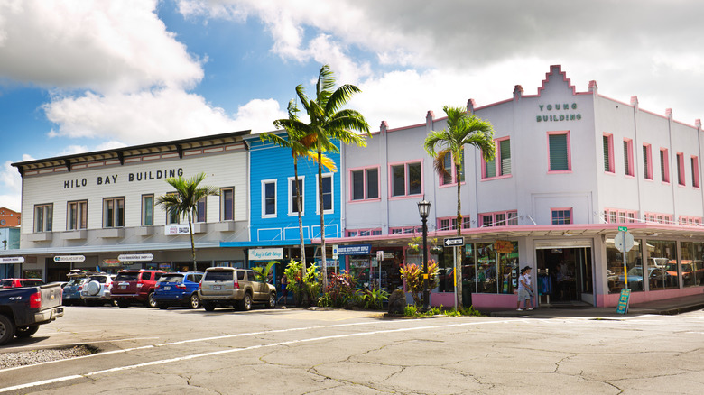 A downtown street view of colorful buildings with palm trees