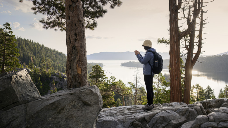 A hiker looking out from the Rubicon Trail over Emerald Bay on Lake Tahoe