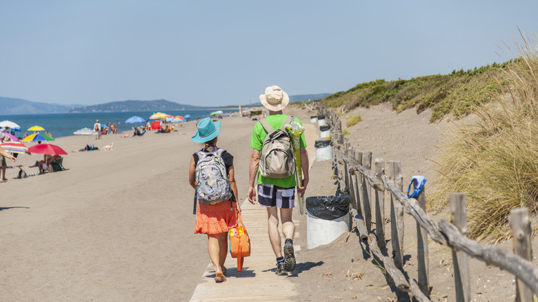 A couple walking on a Tuscan beach