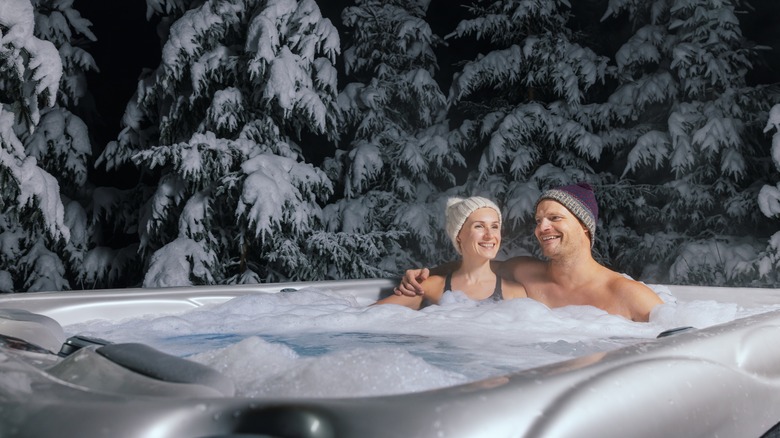 Couple soaking in a hot tub