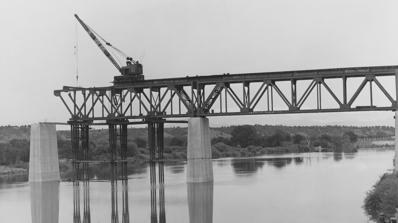 An archival photo shows a crane assembling a trestle bridge in Sacramento, California