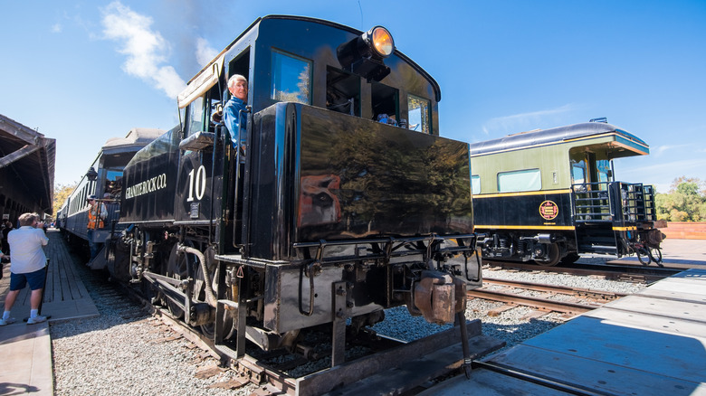 An engineer leans out the window of a locomotive in Sacramento, California