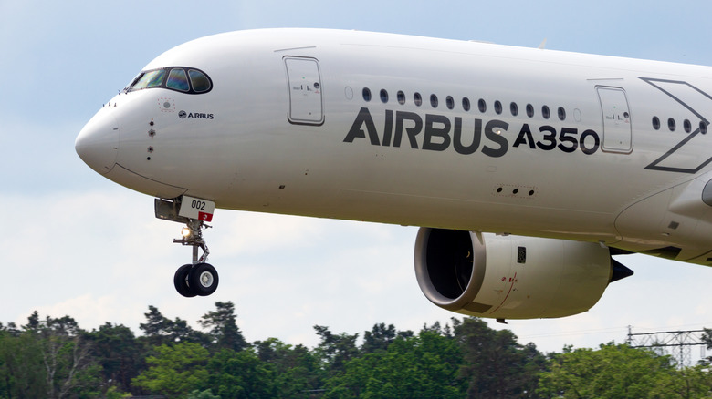 Airbus A350 passenger airplane landing at airport