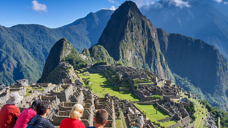 Aerial view of Machu Pichu with tourists gazing at the site