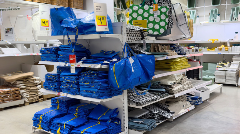 An Ikea endcap featuring the blue, plastic Frakta bags.