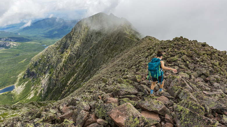 Person hiking along rocky mountain ridge