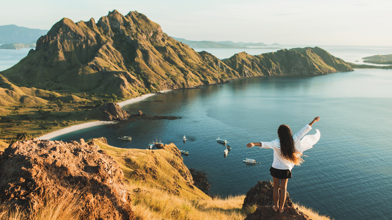 Woman atop a mountain looking at Komodo National Park