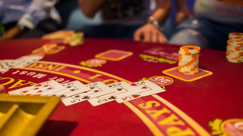 Cards and chips on a casino table.