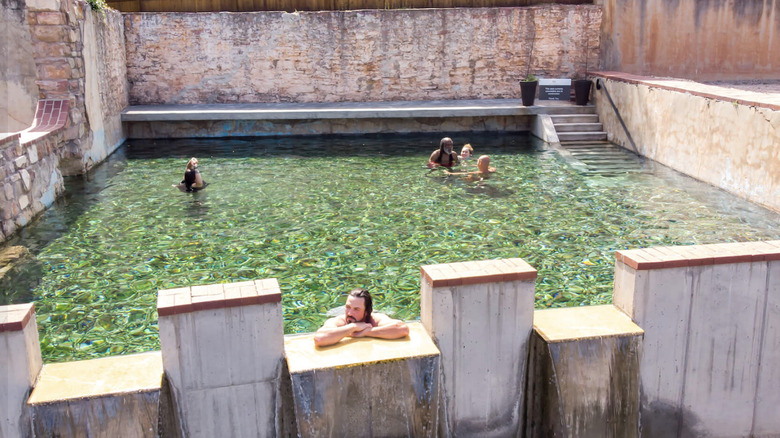 visitors take a dip in Moccasin Springs Natural Mineral Spa in Hot Springs South Dakota