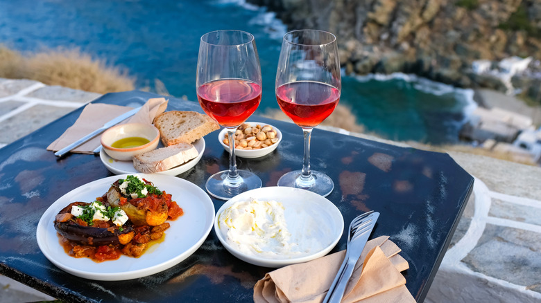 traditional sifnos cuisine served in restaurant overlooking the mediterranean sea