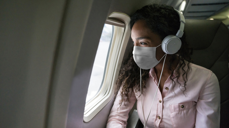 Woman wearing mask on plane